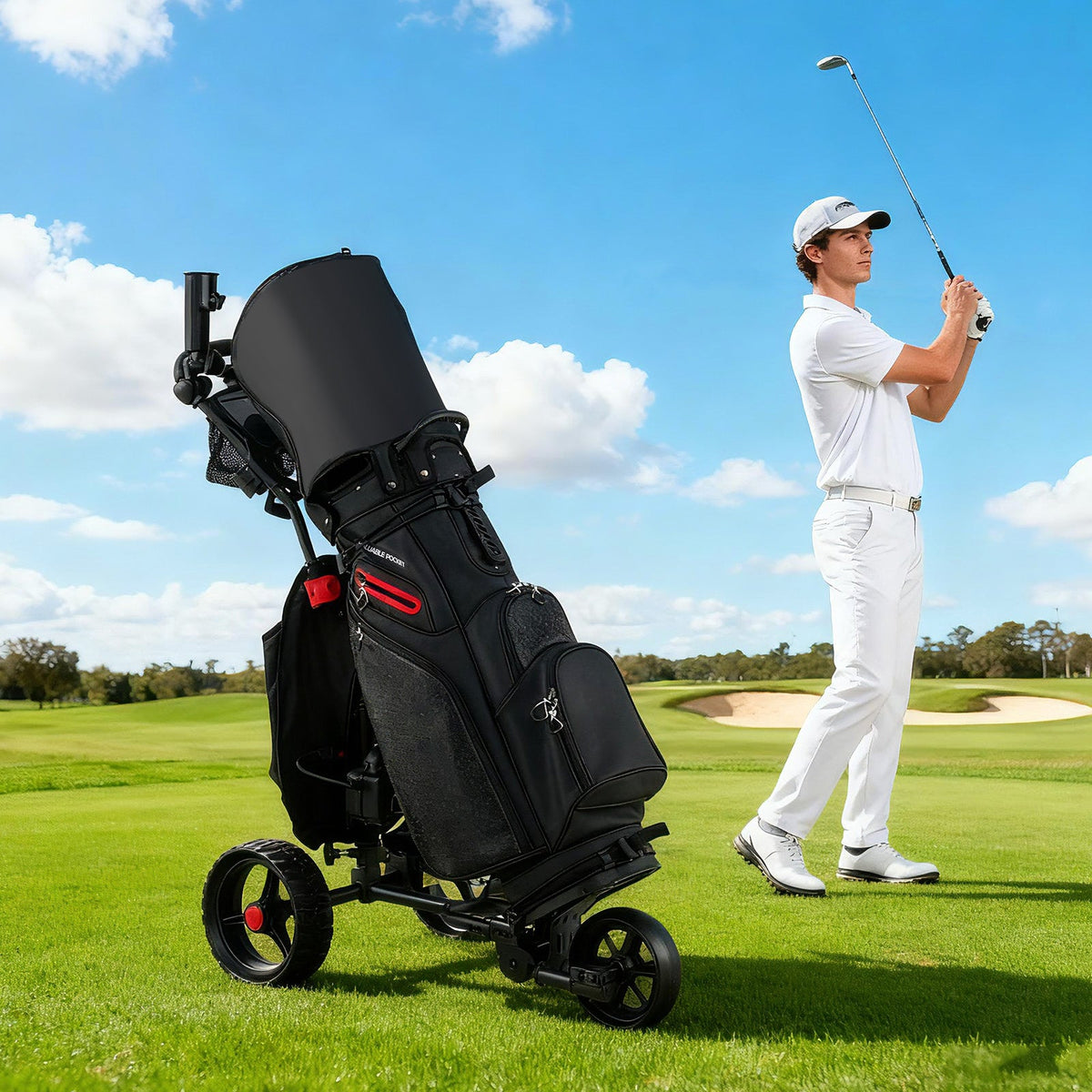 Golfer in white attire swinging on course next to black 3-wheel electric golf cart