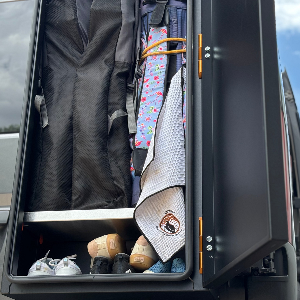 Avatar Offroad Caddie Golf Storage Box open, displaying golf bags and accessories inside